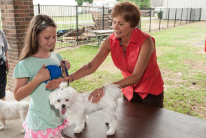 Prayer Ministry Director Jan Niel blesses a young girl's dog at the 2014 Blessing of the Animals.